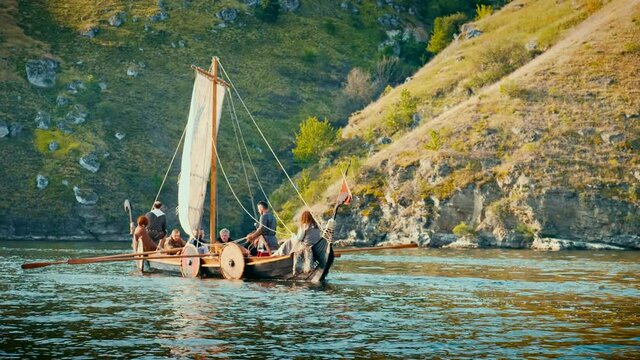 The Men Row the Oars Diligently Towards Adventure. Medieval Reconstruction.