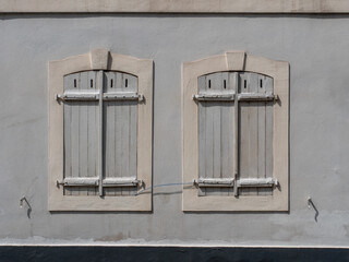 Two old closed windows in the city