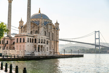 Fototapeta na wymiar Beautiful Istanbul landscape. Sunrise near Bosphorus bridge (aka: 15 July Martyrs Bridge. Turkish: 15 Temmuz Sehitler Koprusu). Grand Imperial Mosque of Sultan Abdulmecid in Ortakoy, Turkey.