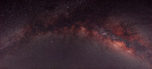 Milky way in panoramic night sky and stars on dark background with noise and grain Photo taken with long exposure and white balance selected.