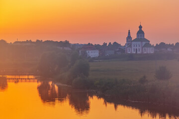 Fototapeta na wymiar Church of Elijah the Prophet at the Kamenka river, Russia. Summer sunny day sunset