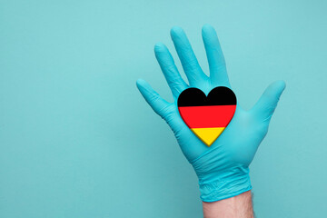 Germany medical health heart. Nurse hand holding country heart flag