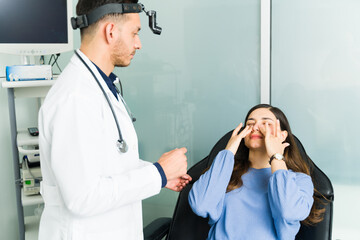 Hispanic doctor listening to a young woman