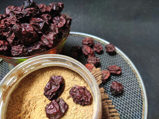 Berr or Dried jujube fruit with powder used in Asian tropical subcontinent as organic herbal medicine top view arranged on black background with selective focus.