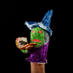 Scary baby finger puppets made of papier mache on hand isolated