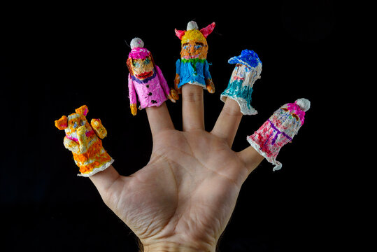 Scary baby finger puppets made of papier mache on hand isolated