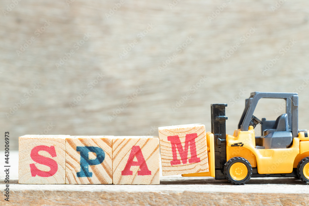 Poster Toy forklift hold letter block m to complete word spam on wood background