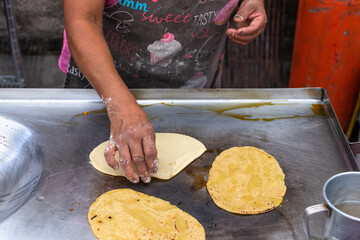 woman's hand preparing a typical mexican food as a quesadillas, sopes, huaraches and more