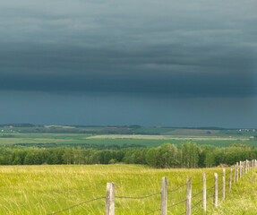 Fototapeta na wymiar landscape with fence and stormy sky