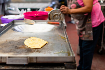 A tortilla for tacos cooking on the grill