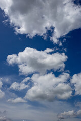 White fluffy clouds in the blue sky background