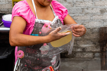 woman's hands making a tortilla in a typical way