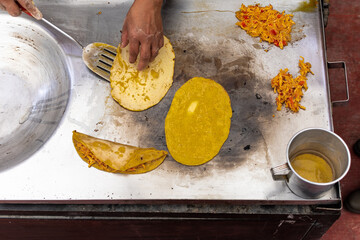 woman's hand preparing a typical mexican food as a quesadillas, sopes, huaraches and more