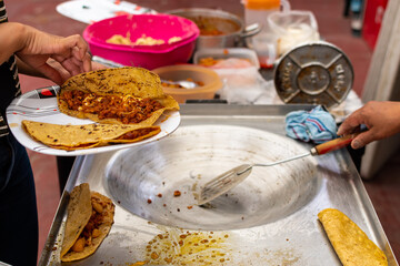 woman's hand preparing a typical mexican food as a quesadillas, sopes, huaraches and more