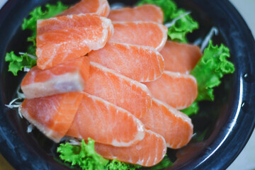Delicious orange salmon fillet with vegetables in a plate.