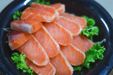 Delicious orange salmon fillet with vegetables in a plate.