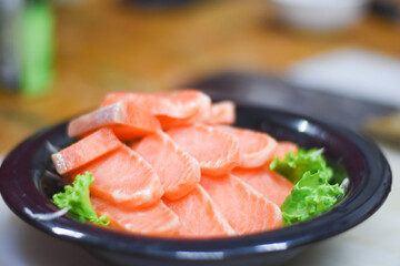 Delicious orange salmon fillet with vegetables in a plate.