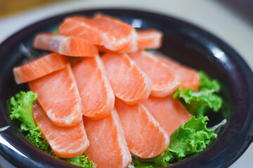 Delicious orange salmon fillet with vegetables in a plate.