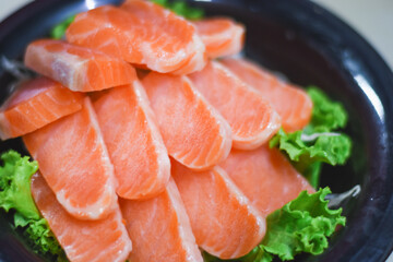 Delicious orange salmon fillet with vegetables in a plate.