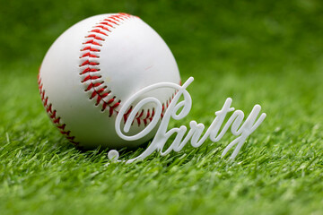 Baseball is on green grass with word Party