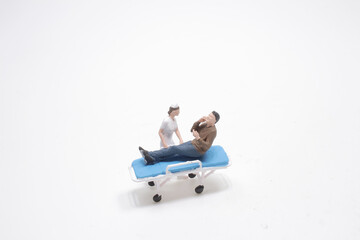 a mini figure Nurses pushing patient on white board