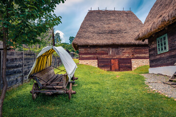 Wonderful summer view of traditional romanian peasant houses. Impressive rural scene of...