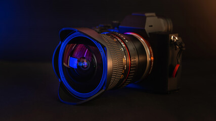 Camera and lens on black background.