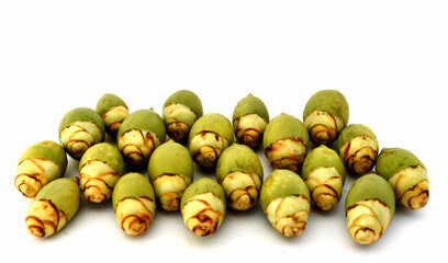 Artistic composition using green betel nut on a white background.