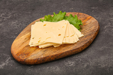 Sliced yellow cheese over board