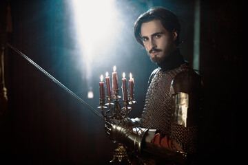 nobleman with sword holding candles