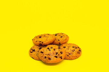 Cookies scattered with yellow background. Simple cookie concept