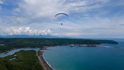 Beautiful aerial view of the extreme sport of paragliding on the Beach and mountains of Costa Rica 