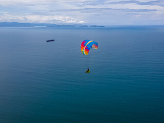 Fototapeta na wymiar Beautiful aerial view of the extreme sport of paragliding on the Beach and mountains of Costa Rica 