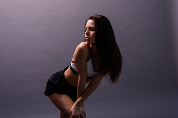 Young and beautiful dancer posing in studio