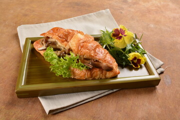 asian stir fried assorted mushroom and vegetables in freshly baked croissant on bamboo plate and flower wood table fusion halal vegetarian vegan menu
