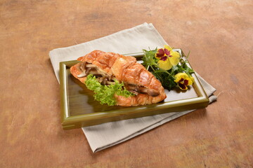 asian stir fried assorted mushroom and vegetables in freshly baked croissant on bamboo plate and...