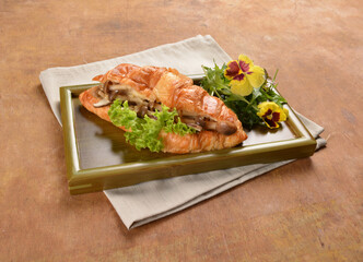 asian stir fried assorted mushroom and vegetables in freshly baked croissant on bamboo plate and...