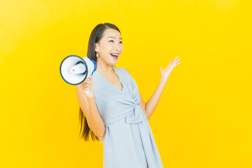 Portrait beautiful young asian woman smile with megaphone