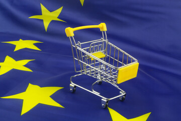Shopping cart on EU flag. Shopping activity in European Union concept.	