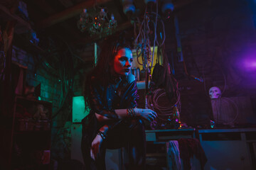 Fototapeta na wymiar Cyberpunk girl in a post-apocalyptic futuristic style in a garage
