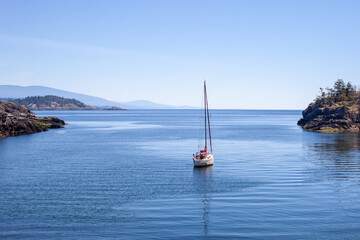 A sailboat is anchored (moored) in a small cove on the southern end of Thormanby Island, on the...
