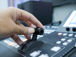 hand on dissolve of switcher buttons in studio TV station,Television Broadcast.