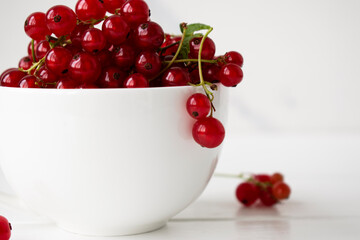 red currants in a white cup