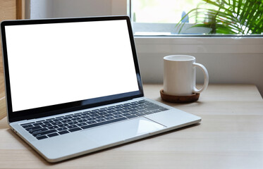 Fototapeta premium Modern workspace with computer with blank screen and equipment on white table.Blank screen for your information.