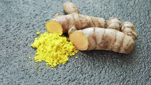 Fresh turmeric rhizome and powder. Yellow curcumin. Curcuma