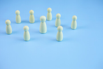 Wood person symbol icon standing on pastel blue background, copy space.