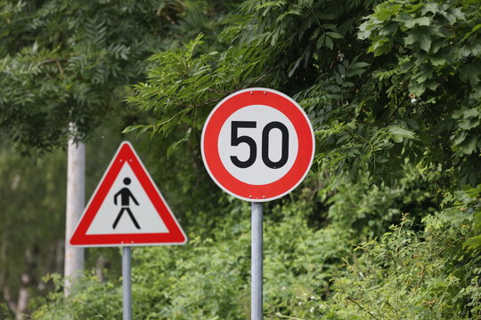 Round speed limit road sign on the road. 50 km per hour