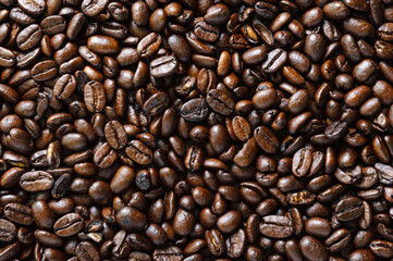 Roasted full coffee beans close-up. Coffee background. Top view, flat lay.