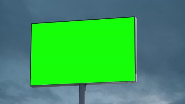  Empty large billboard with a green screen for advertising against blue sky with clouds timelapse 