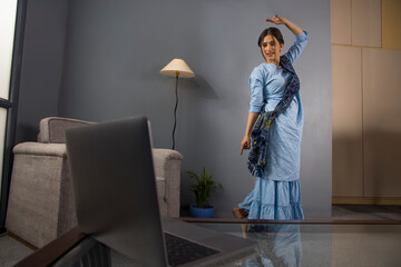 A classical dancer teaching steps in online class.